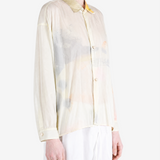 Tan shirt worn by a person, showing the shirt fit