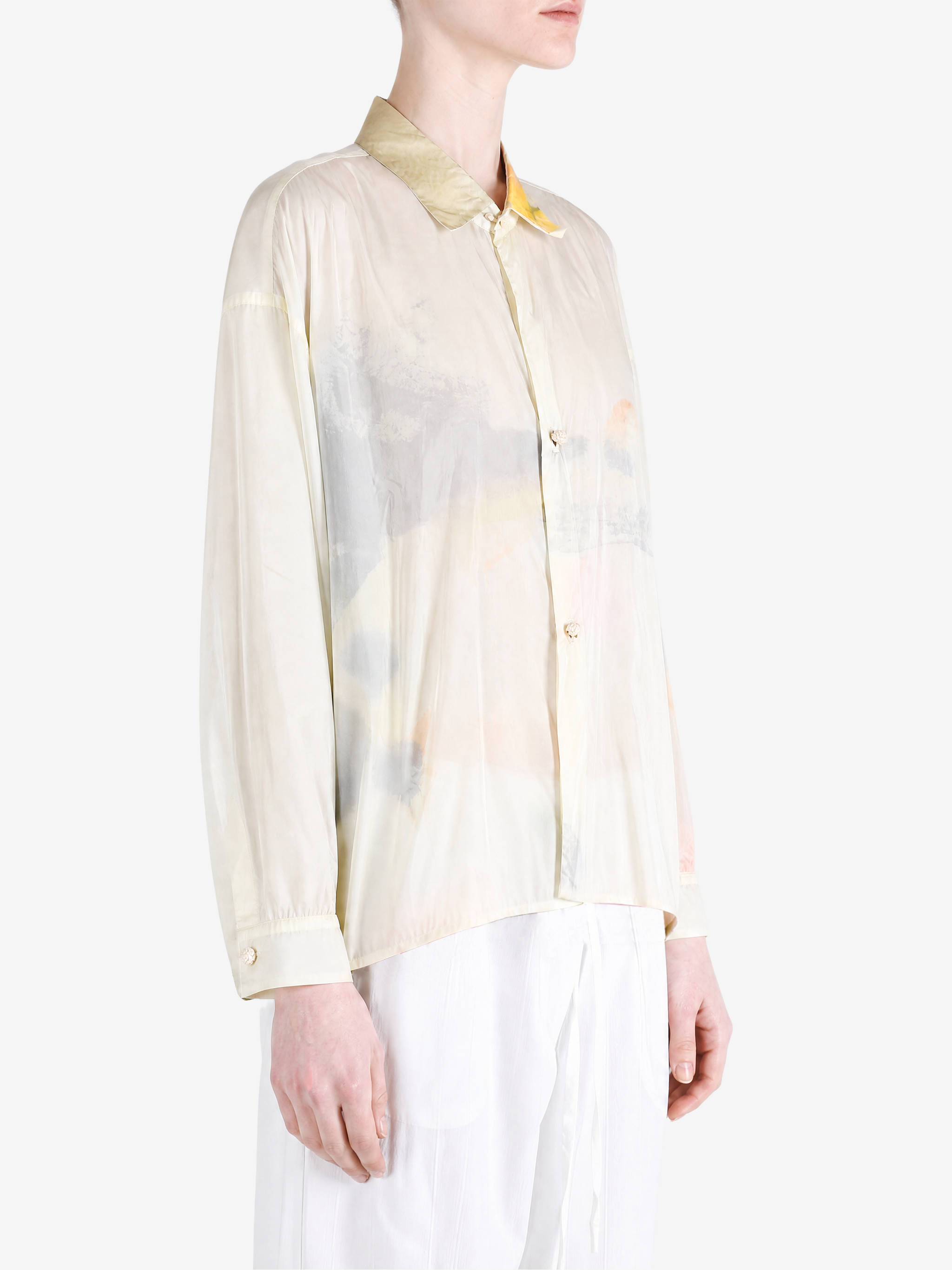 Tan shirt worn by a person, showing the shirt fit