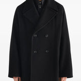 Black jacket worn by a person, showing the jacket fit