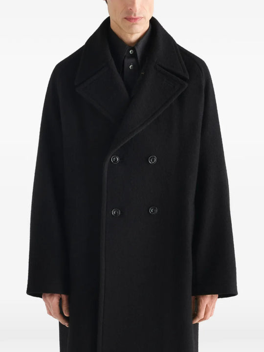 Black jacket worn by a person, showing the jacket fit