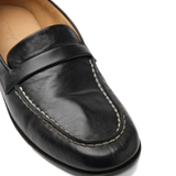 Close up of brown shoes, showing texture of the Calf Leather fabric 