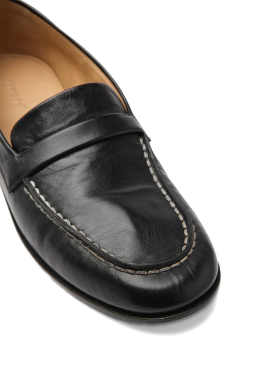 Close up of brown shoes, showing texture of the Calf Leather fabric 