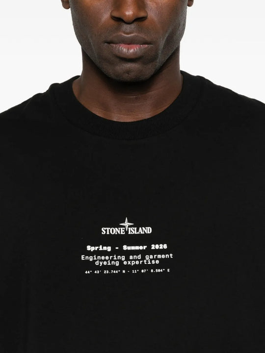 Close up of black t-shirts, showing texture of the organic cotton fabric