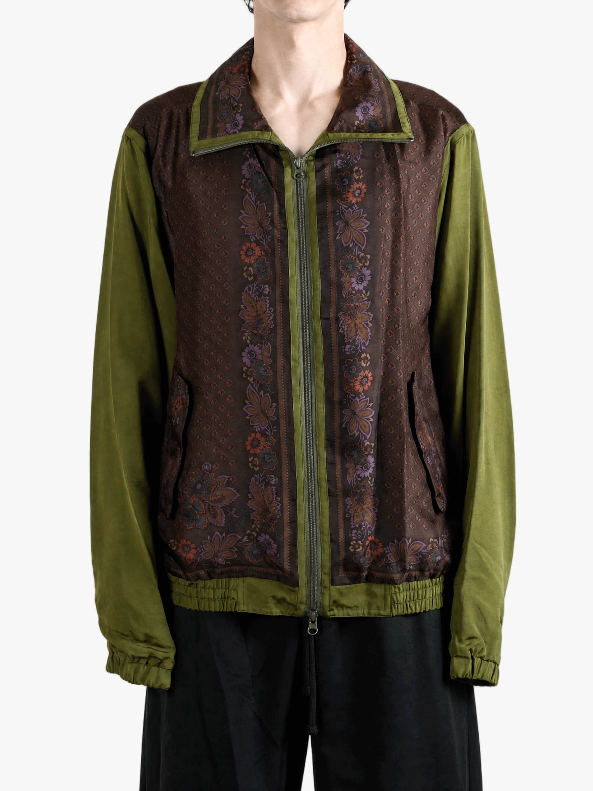 Green jacket worn by a person, showing the jacket fit