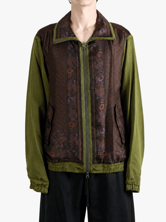 Green jacket worn by a person, showing the jacket fit