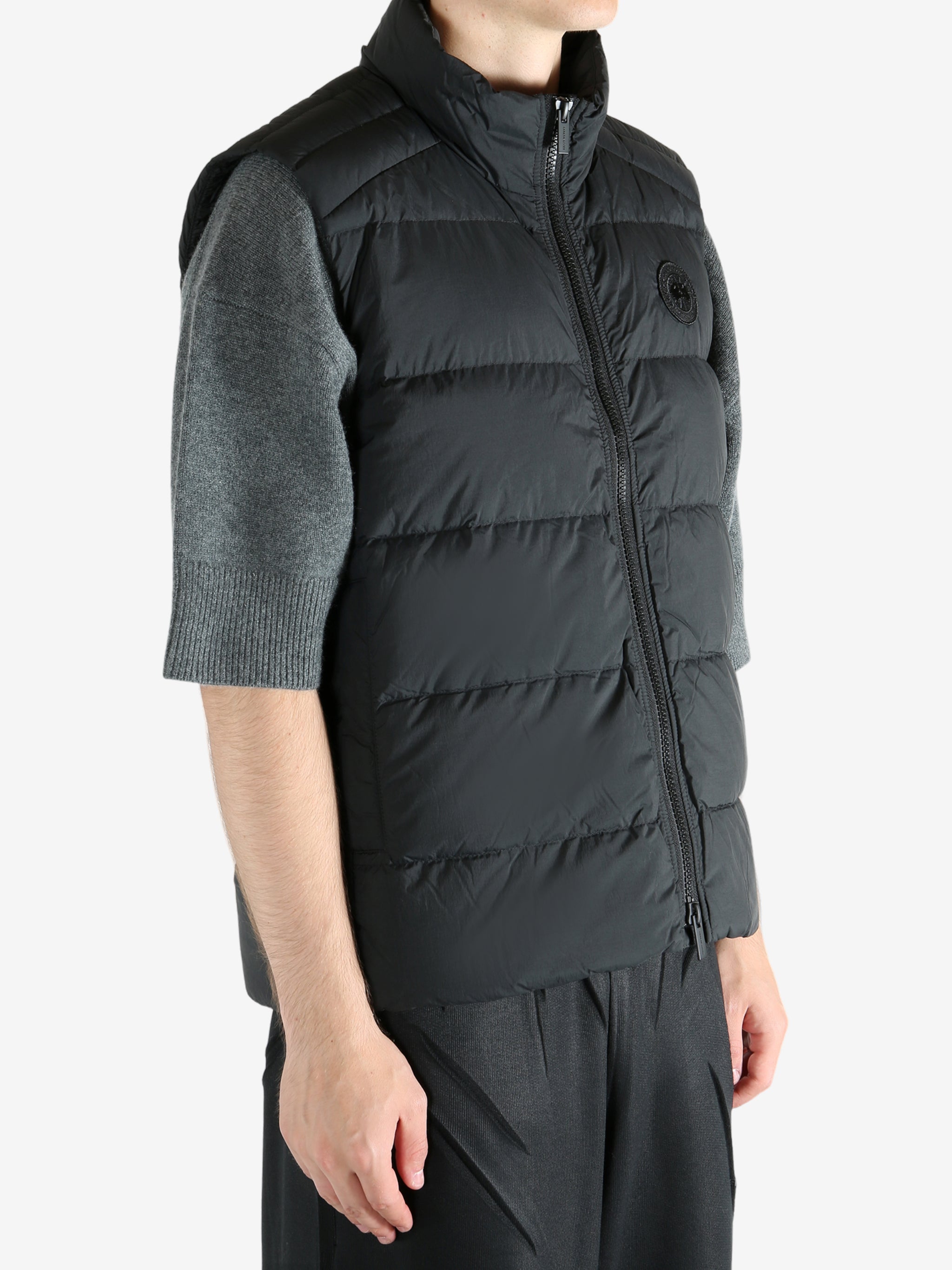 Black vest worn by a person, showing the vest's fit