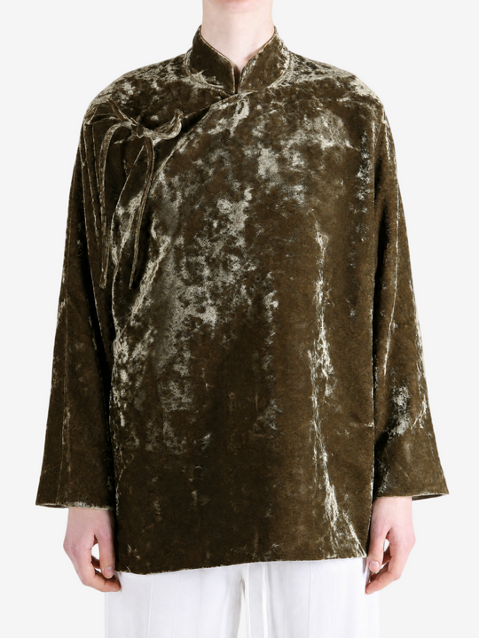 Green jacket worn by a person, showing the jacket fit