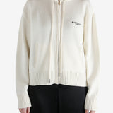 White knitwear worn by a person, showing the knitwear fit