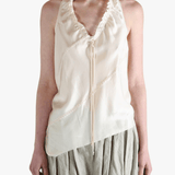 White top worn by a person, showing the top's fit