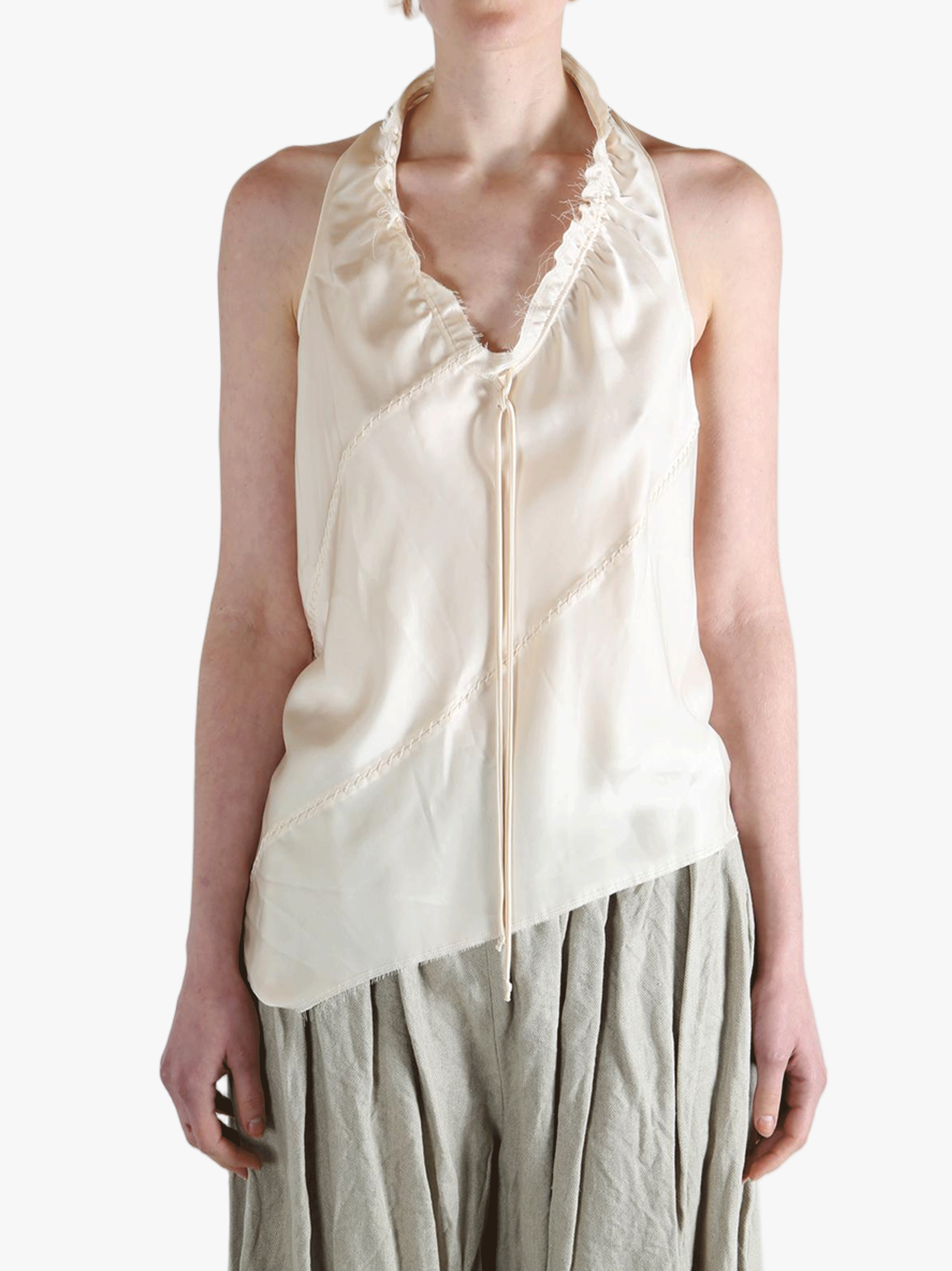 White top worn by a person, showing the top's fit