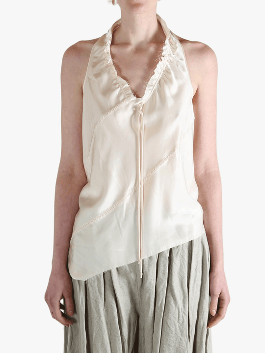 White top worn by a person, showing the top's fit