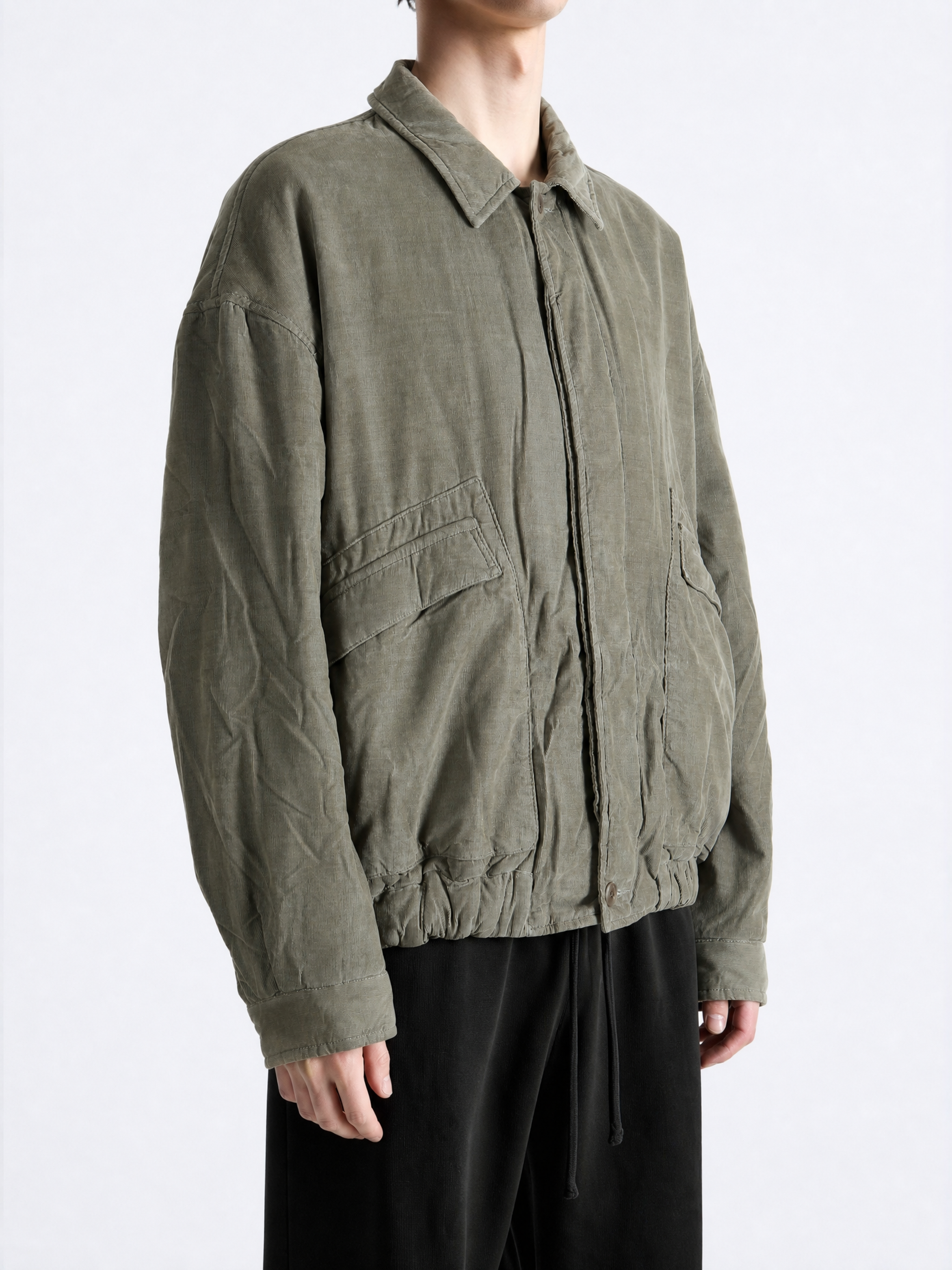 Green jacket worn by a person, showing the jacket fit