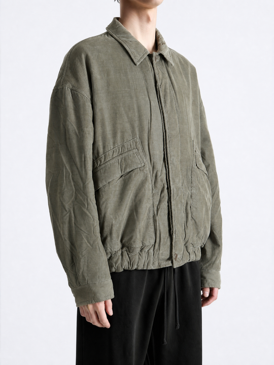 Green jacket worn by a person, showing the jacket fit