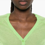 Green top worn by a person, showing the top fit