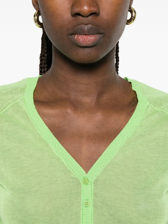 Green top worn by a person, showing the top fit