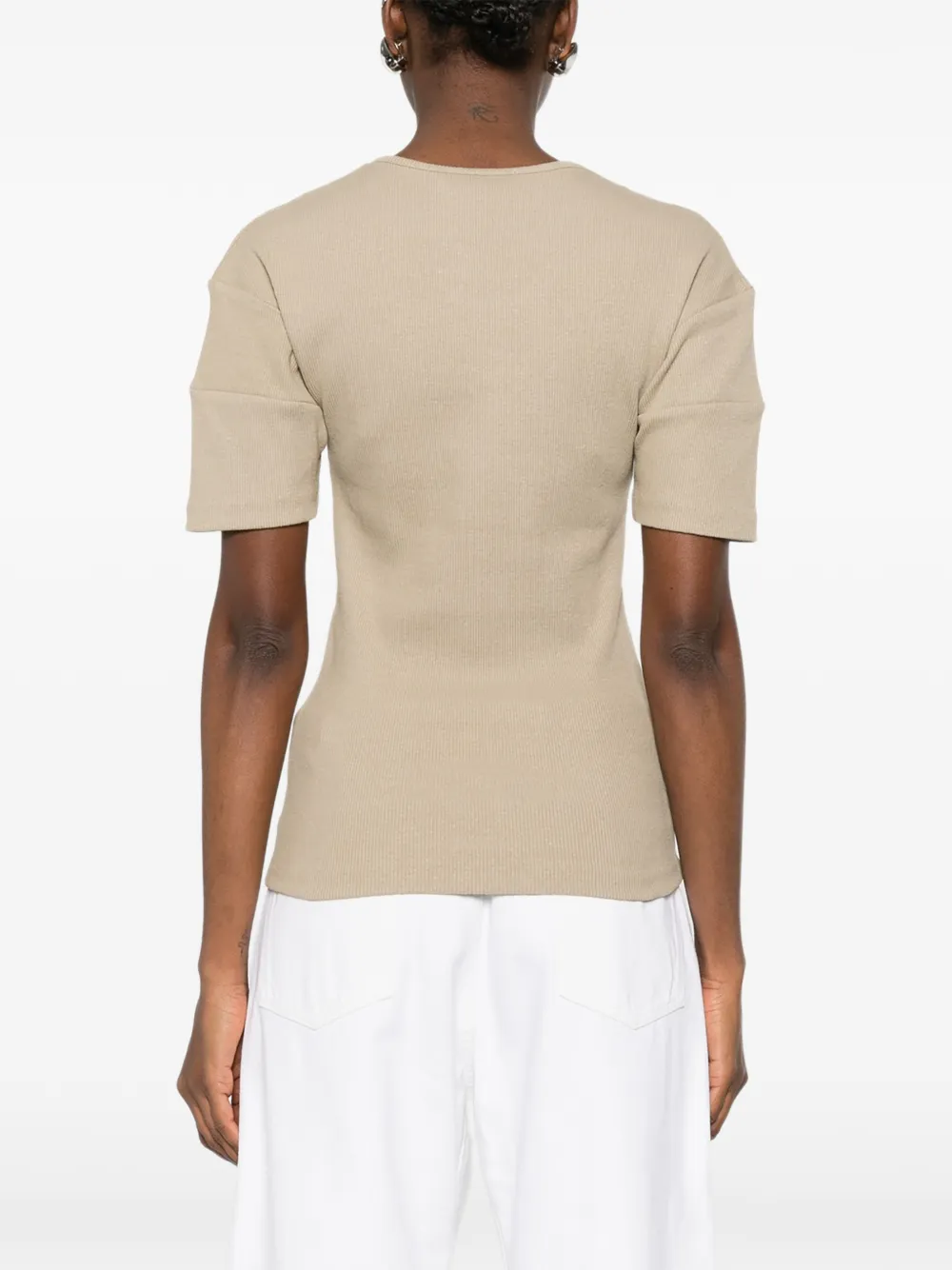Tan shirt worn by a person, showing the shirt fit
