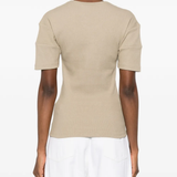 Tan shirt worn by a person, showing the shirt fit