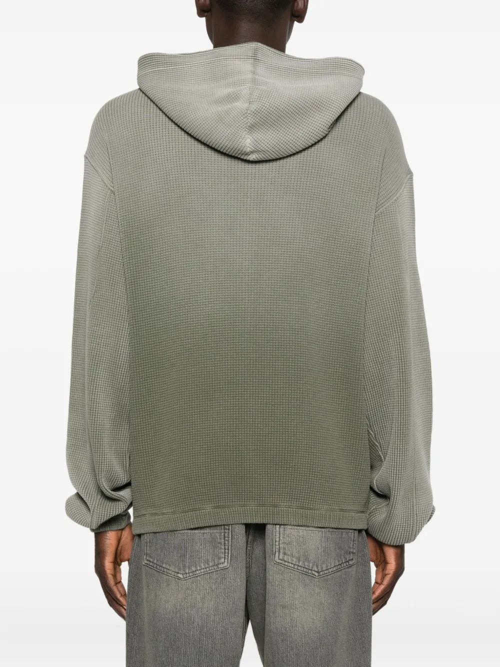 Green hoodie worn by a person, showing the hoodie's fit