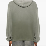 Green hoodie worn by a person, showing the hoodie's fit