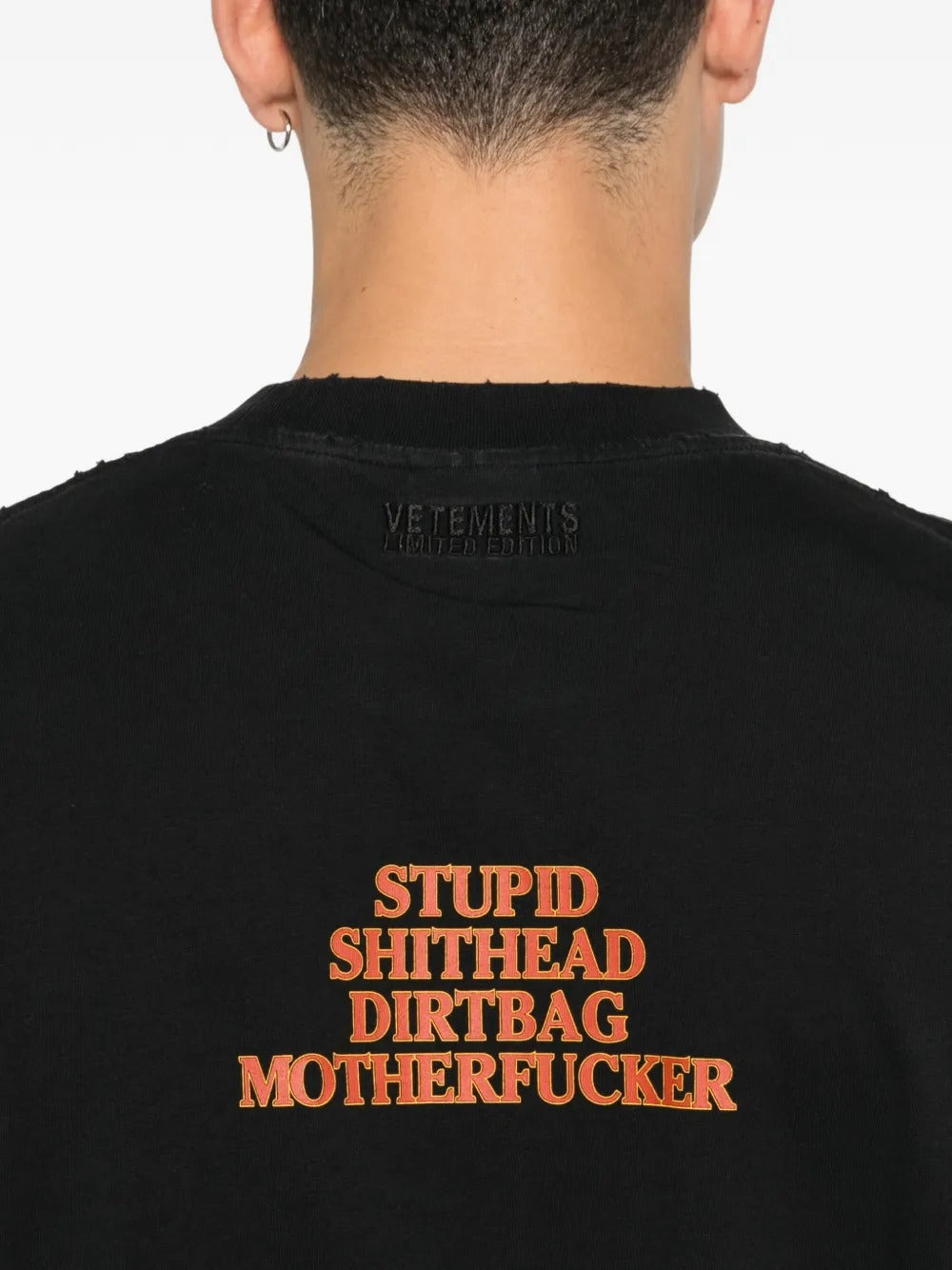 Close up of black t-shirts, showing texture of the cotton fabric