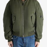 Green jacket worn by a person, showing the jacket fit