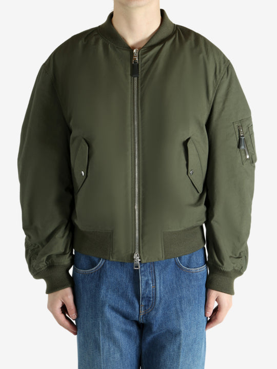Green jacket worn by a person, showing the jacket fit