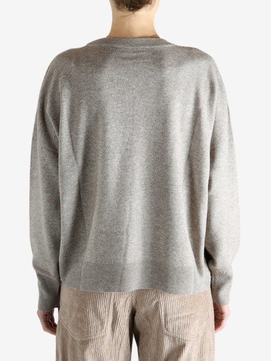 Grey knitwear worn by a person, showing the knitwear fit