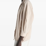 Tan top worn by a person, showing the top's fit