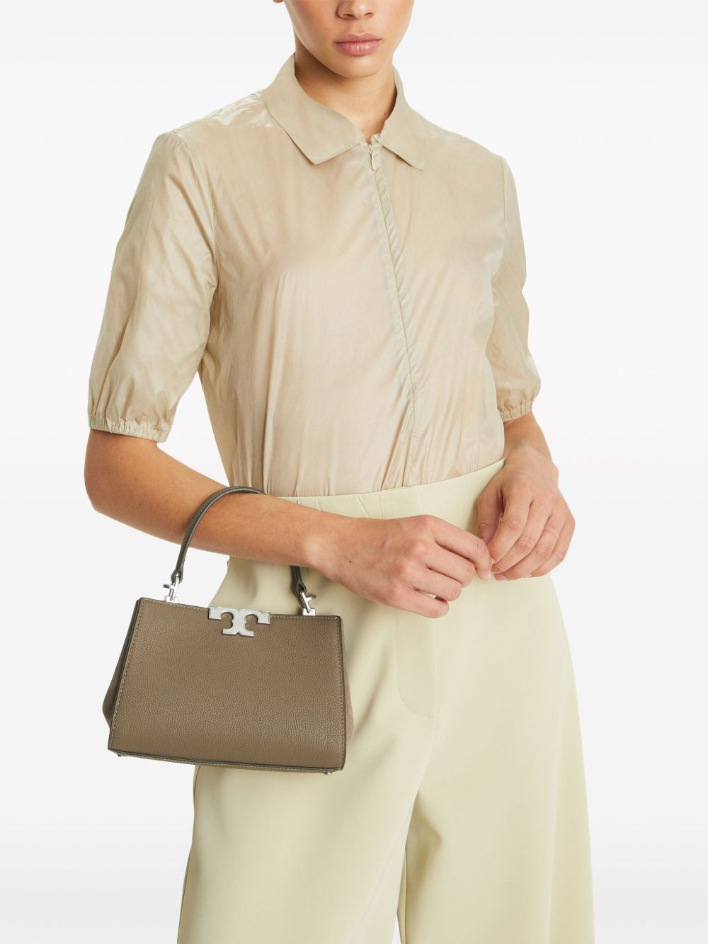 Brown bag carried by a person, showing the bag’s fit