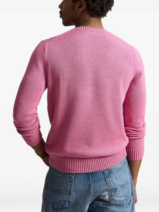 Pink knitwear worn by a person, showing the knitwear fit