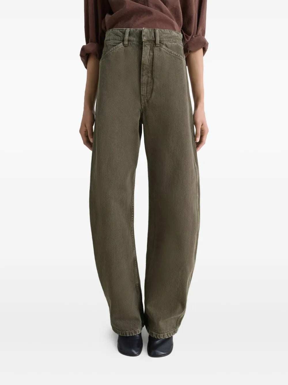 Green jeans worn by a person, showing the jeans' fit