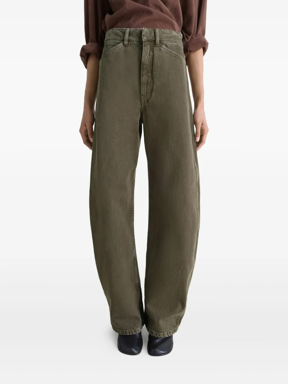 Green jeans worn by a person, showing the jeans' fit