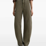 Green jeans worn by a person, showing the jeans' fit