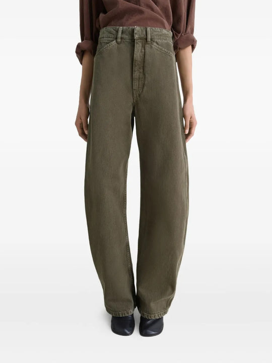 Green jeans worn by a person, showing the jeans' fit