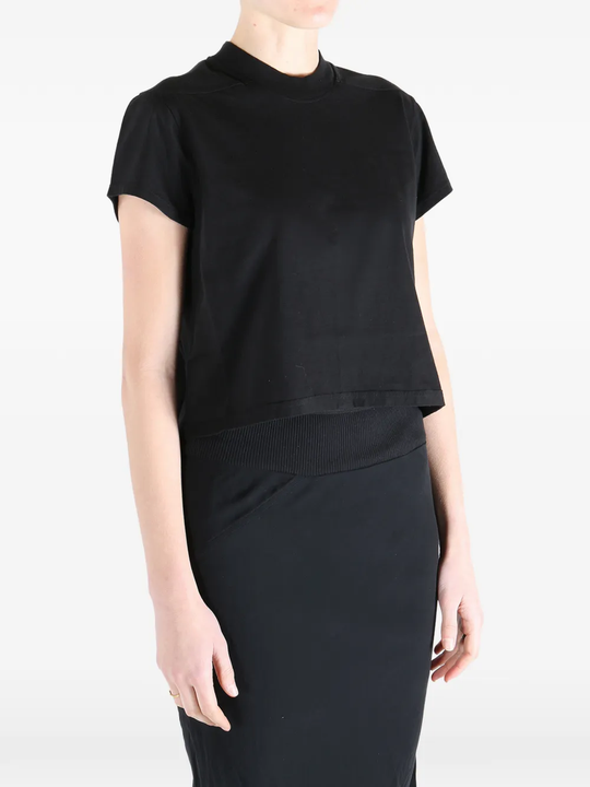 Black t-shirt worn by a person, showing the t-shirt fit