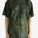 Green t-shirt worn by a person, showing the t-shirt's fit