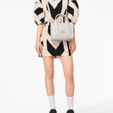 White bag worn by a person, showing the bag's fit