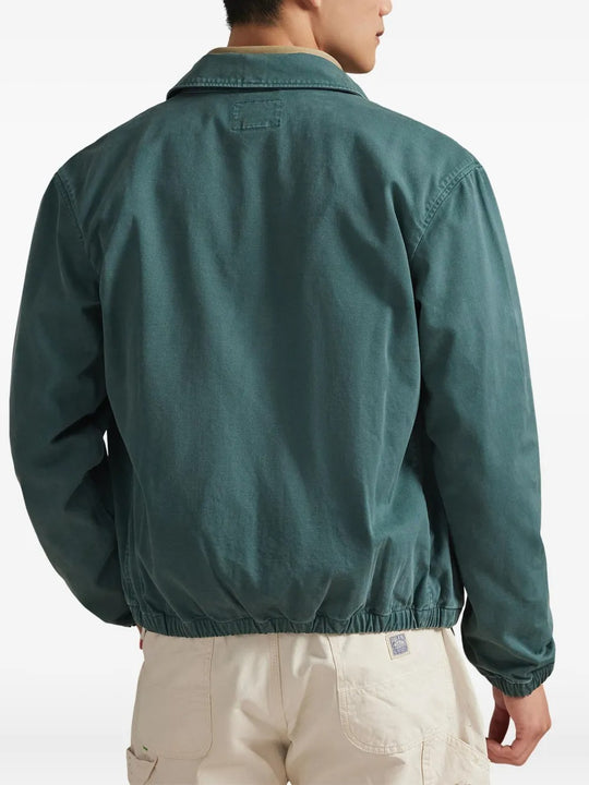 Green jacket worn by a person, showing the jacket's fit