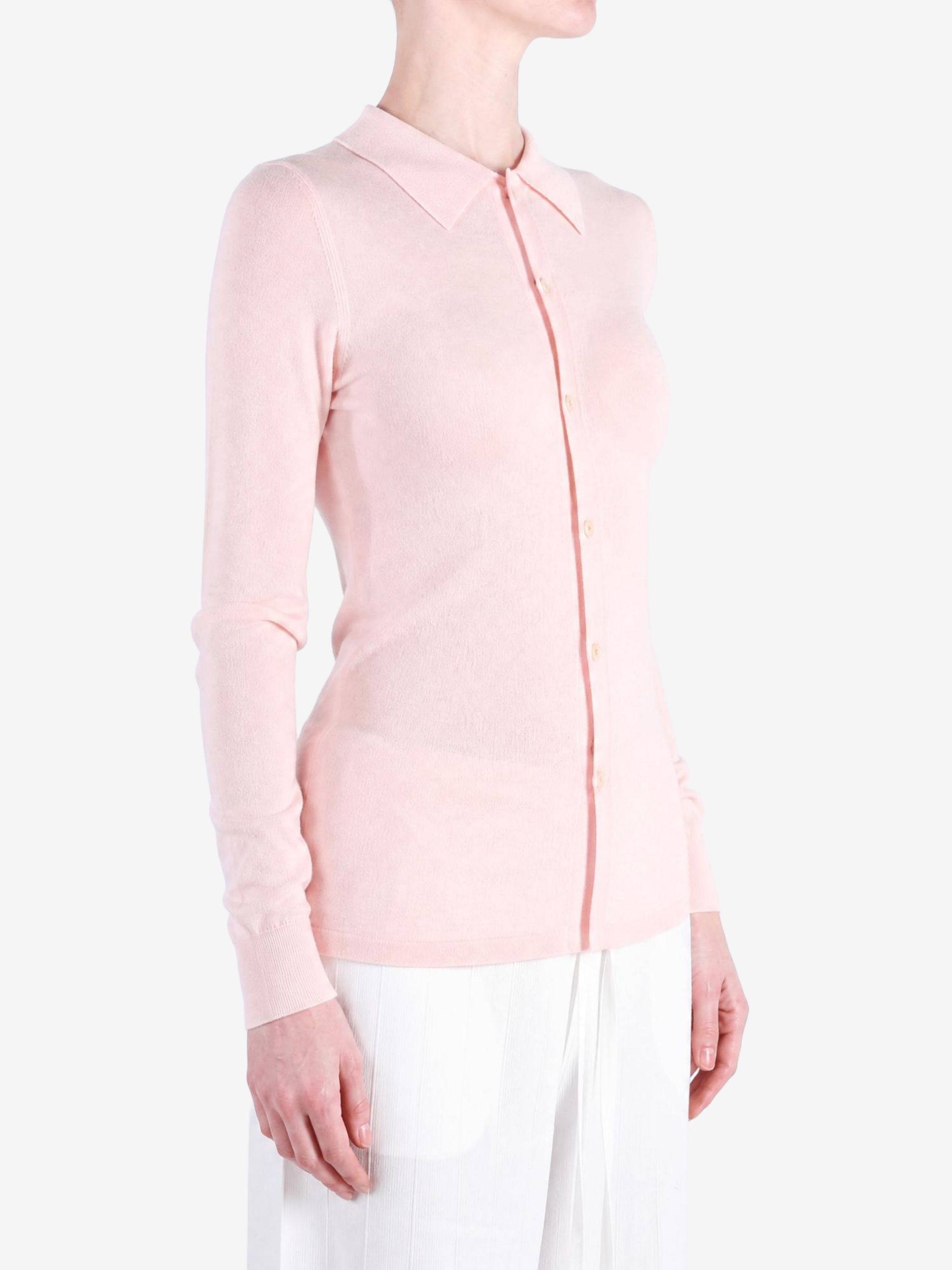 Pink knitwear worn by a person, showing the knitwear fit
