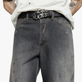 Black jeans worn by a person, showing the jeans fit