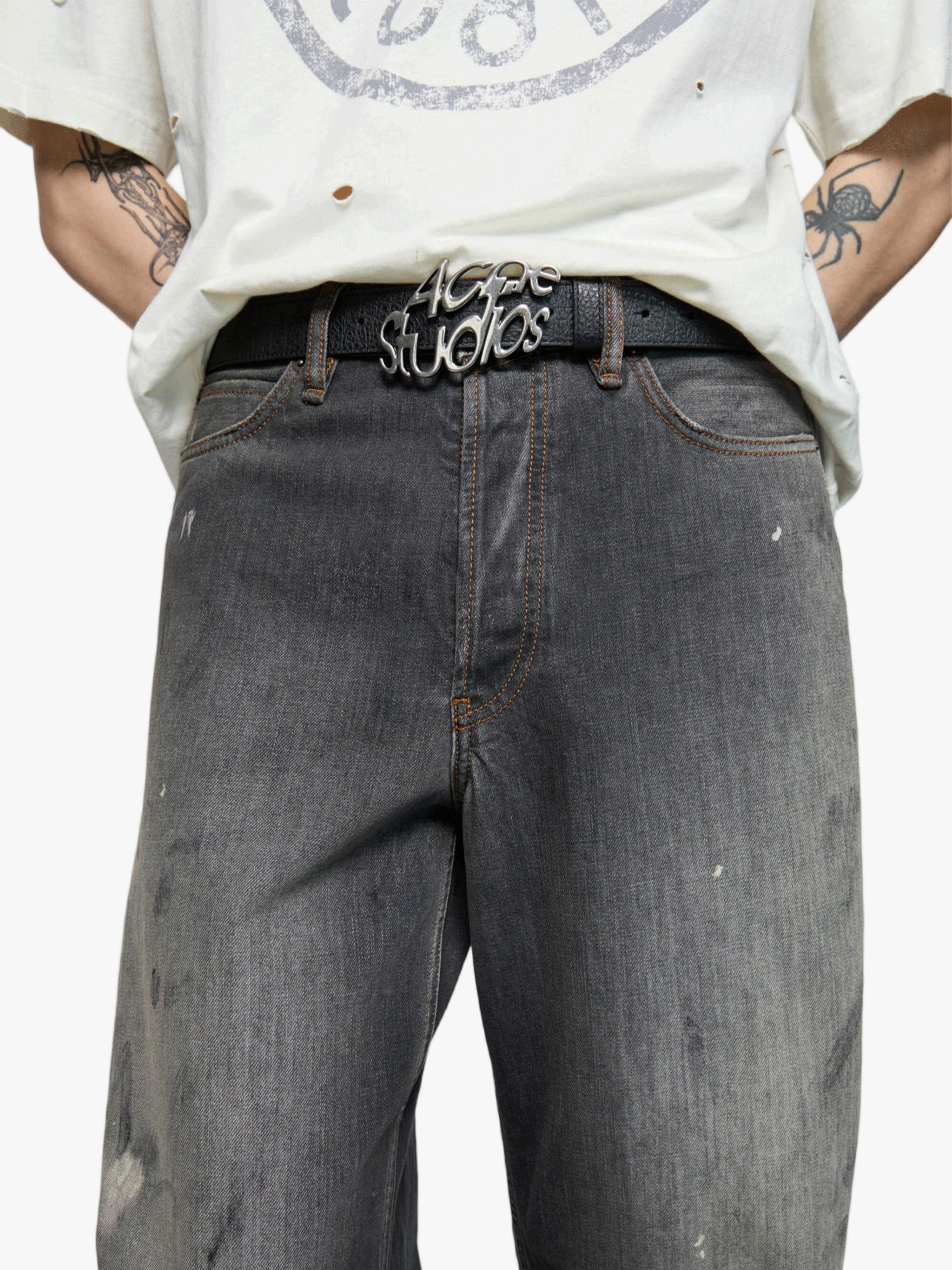 Black jeans worn by a person, showing the jeans fit