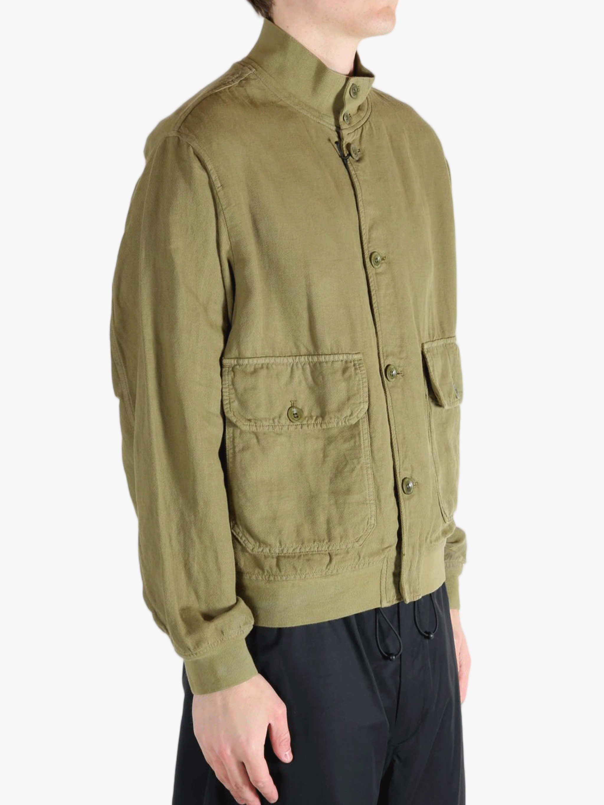 Green jacket worn by a person, showing the jacket's fit