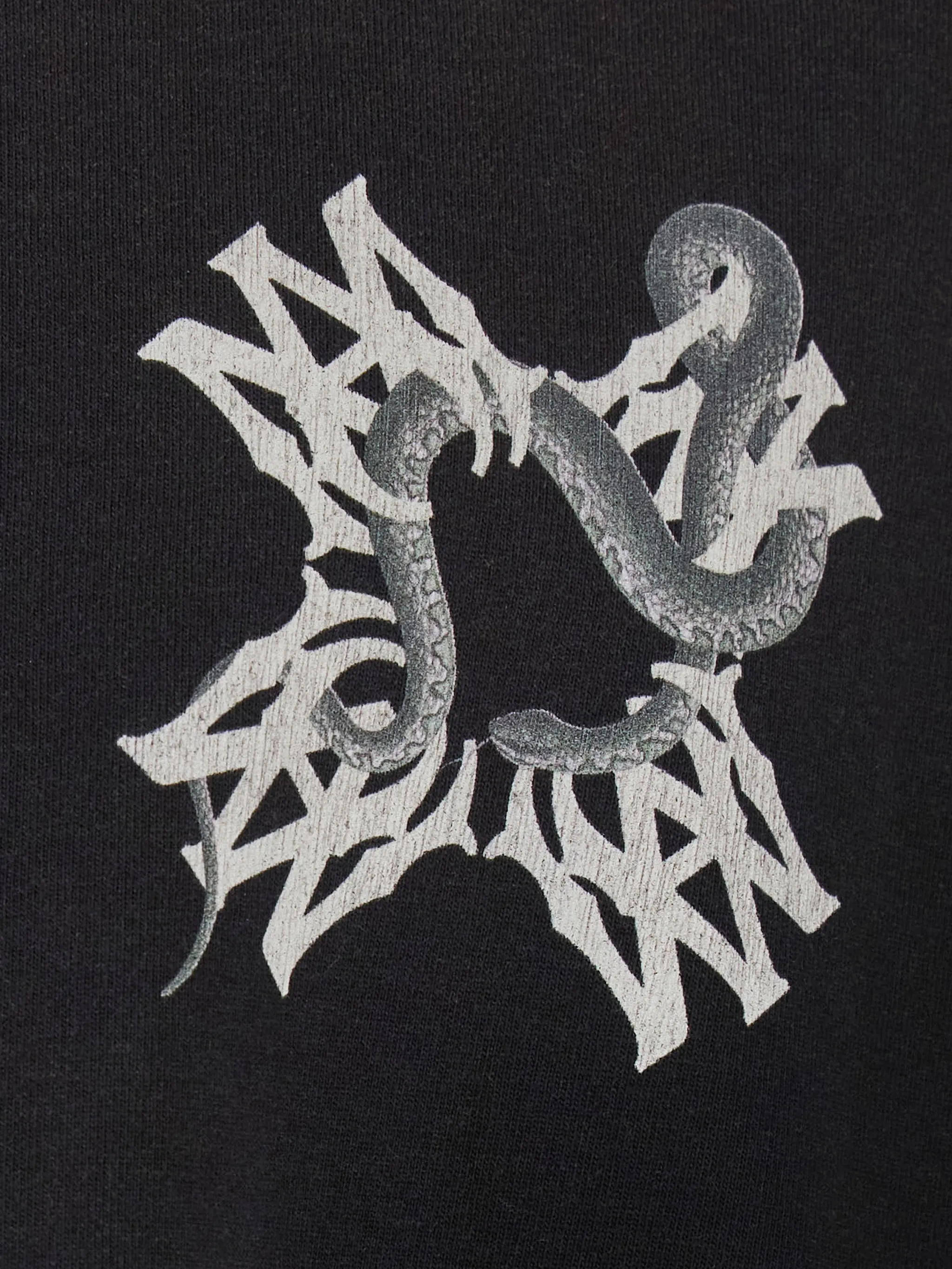 Close up of black t-shirt, showing texture of the cotton fabric
