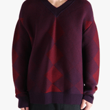 Red sweater worn by a person, showing the sweater fit