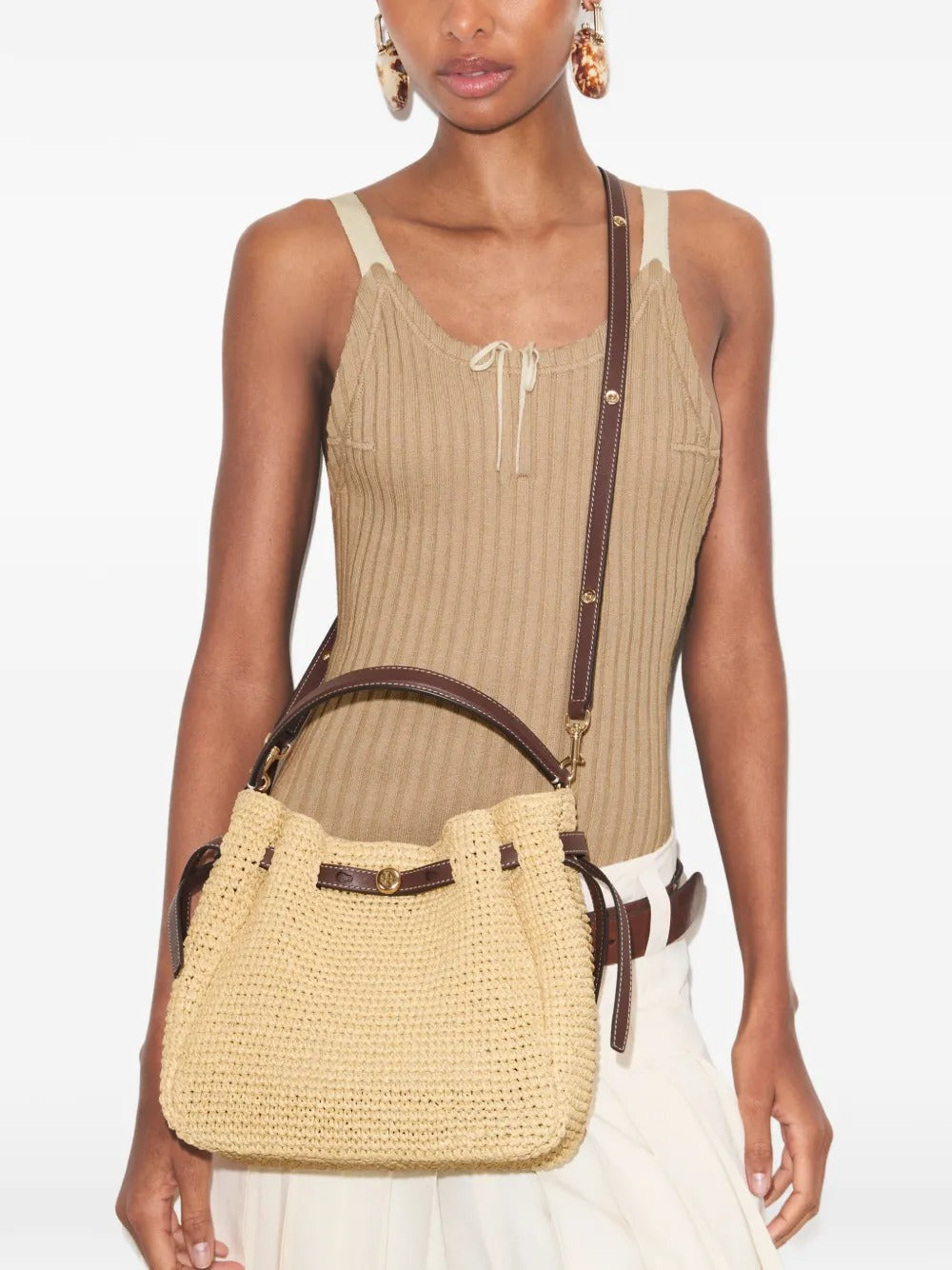 Tan bags worn by a person, showing the bags' fit 