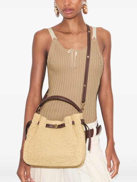 Tan bags worn by a person, showing the bags' fit 