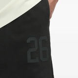 Close up of the black pants, showing texture of the cotton fabric