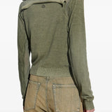 Green knitwear worn by a person, showing the knitwear's fit