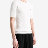 White hoodie worn by a person, showing the hoodie fit