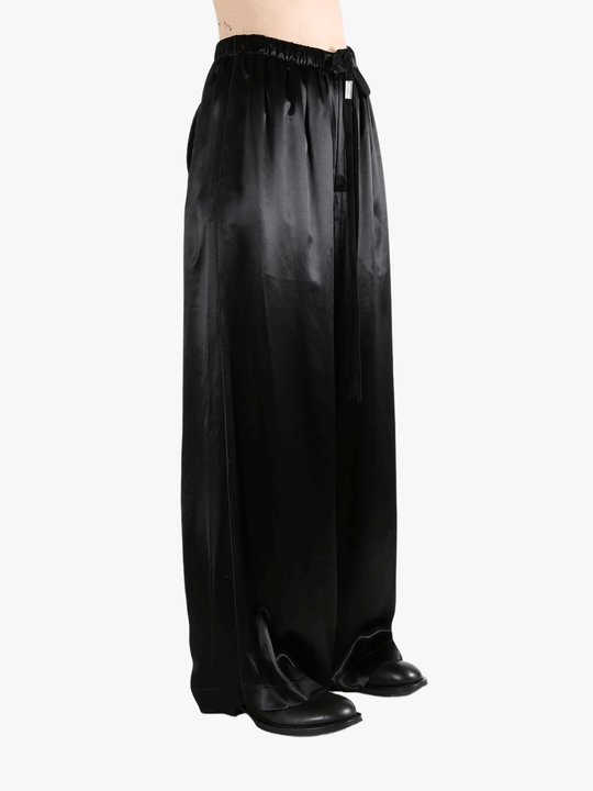 Black pants worn by a person, showing the pant's fit